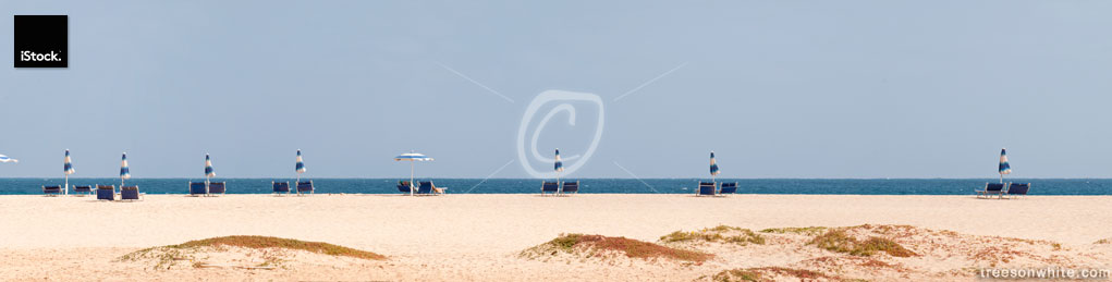 Beach chairs and umbrellas in front of blue Atlantic Ocean/Panor